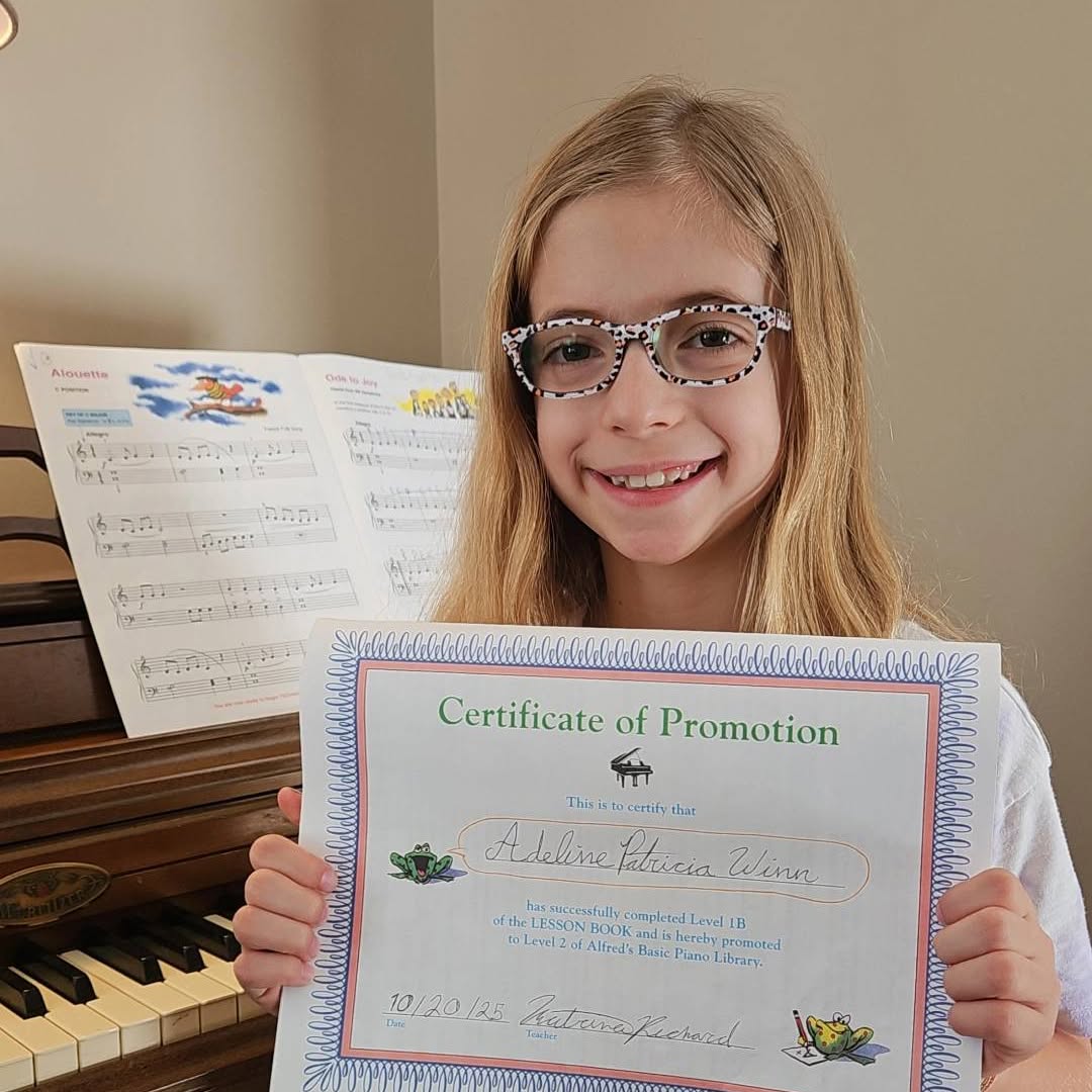 A student with her certificate of promotion